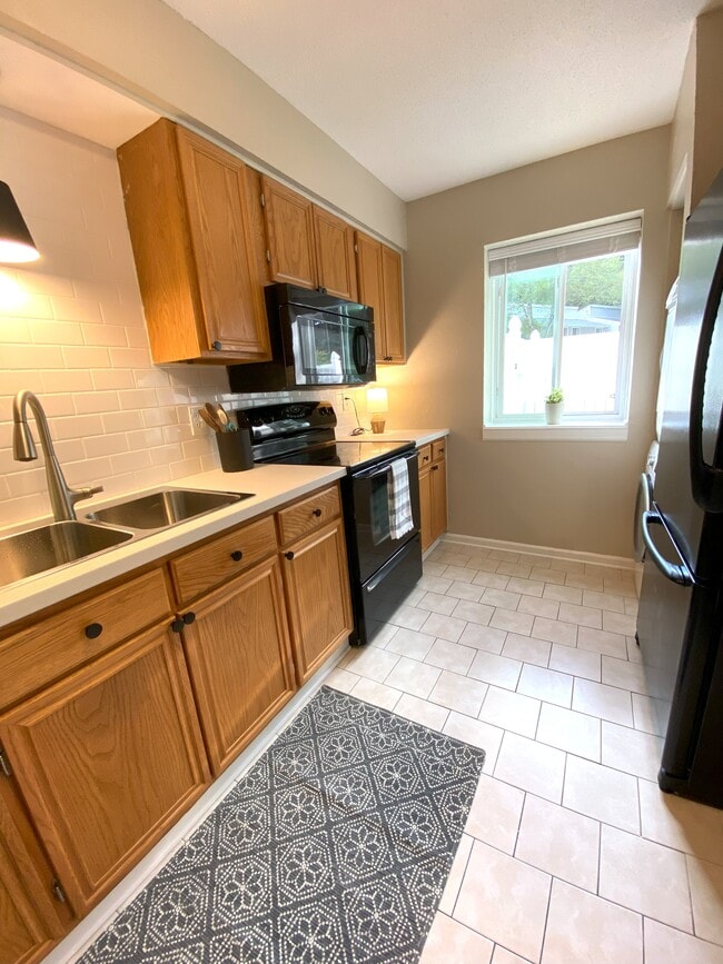 kitchen, with view into courtyard - 7408 Sandy Creek Dr