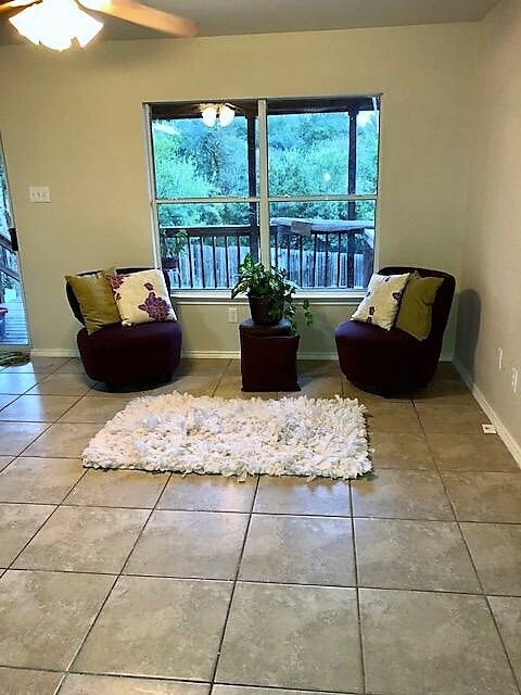 living room with hard tile floors has a view of the deck and back yard - 10617 Garbacz Dr
