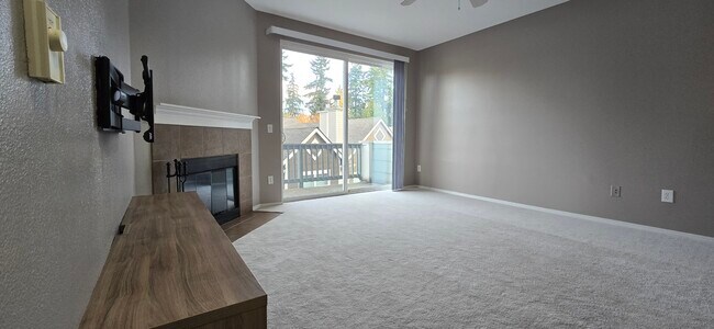 Entertainment center, TV wall mount, wood burning fireplace, balcony, living room - 3116 164th St SW