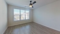 This contemporary 660 square foot apartment in Waxahachie, TX offers a harmonious blend of style and functionality. The open-concept layout maximizes the use of space, creating a seamless flow between the living areas. The kitchen is a standout feature, boasting dark wood cabinetry, stainless steel appliances, and a striking contrast with white subway tile backsplash. A generous granite countertop extends to form a breakfast bar, perfect for casual dining or entertaining.

The bathroom exudes elegance with its granite vanity, large framed mirror, and modern lighting fixtures. Light wood-look flooring runs throughout the main living areas, while plush carpeting adds comfort to the bedroom. Large windows in both the living room and bedroom flood the space with natural light and offer pleasant views of the surrounding area.

The bedroom, measuring 130 square feet, provides ample space for rest and relaxation. A modern ceiling fan adds both style and functionality. The apartment's neutral color palette creates a calm and inviting atmosphere, allowing for easy personalization. With its thoughtful design and quality finishes, this apartment offers a comfortable and stylish living experience in a prime location.