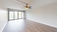 Located at 1769 Robin Ln in Lisle, IL, this one-bedroom, one-bathroom unit offers a thoughtfully designed single-floor layout with modern updates throughout. The open living room is bright and welcoming, featuring light wood-look flooring, a ceiling fan, and sliding glass doors that lead to a private balcony overlooking tree-lined surroundings and the community grounds.

The kitchen is a standout feature, showcasing white shaker cabinetry with matte black hardware, crisp white countertops, a subway tile backsplash, and a full suite of stainless steel appliances including a refrigerator, dishwasher, gas range, and microwave. A peninsula with a white countertop connects the kitchen to the living area, enhancing the open flow of the space.

The bedroom is generously sized, offering plush carpeting, neutral wall tones, and a large window that fills the room with natural light and views of the greenery outside. A closet provides dedicated storage within the bedroom. The bathroom is clean and functional, featuring a tub-shower combination with white tile surround, wood-look flooring, and brushed nickel fixtures. The unit's neutral palette and updated finishes create a cohesive, move-in-ready atmosphere throughout.
