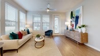 This thoughtfully designed single-floor residence offers a comfortable and functional layout across a well-utilized footprint. A welcoming entry hallway with recessed lighting and light wood-style flooring guides residents through the space, with multiple closets conveniently positioned for storage.

The open-concept kitchen and living area serves as the heart of the home. The kitchen is outfitted with crisp white shaker cabinetry, a classic subway tile backsplash, stainless steel appliances including a gas range, built-in microwave, dishwasher, and refrigerator, along with a sleek marble-topped island ideal for dining or meal prep. The adjoining living room is bright and airy, featuring multiple large windows that flood the space with natural light and offer outdoor views, complemented by a ceiling fan overhead.

The bedroom is a comfortable retreat with its own natural light from dual windows, a ceiling fan, and hardwood-style flooring. It provides direct access to the full bathroom, which includes a shower-tub combination. Three closets throughout the unit ensure generous storage. A dedicated laundry area adds everyday convenience. Neutral tones and clean finishes throughout give the entire residence a modern, cohesive aesthetic.