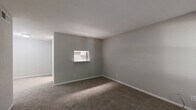 Located at 2730 Lafferty Rd in Pasadena, Texas, this single-floor unit offers a practical and well-organized layout with 2 bedrooms, 3 bathrooms, a living room, and a hallway connecting the main spaces. The living room features neutral gray walls, plush wall-to-wall carpeting, and a window with blinds that allows natural light to filter in, creating a calm and open atmosphere. A pass-through window connects the living area to the kitchen, adding a convenient architectural touch. The spacious primary bedroom is generously sized, finished with soft carpeting, neutral tones, and a window overlooking greenery. It is complemented by a walk-in closet equipped with built-in shelving and hanging rods, offering ample storage. The second bedroom is equally comfortable, with carpeted floors, a textured ceiling, and a window that brings in natural light. All three bathrooms are clean and functional, each featuring a tub-shower combination with tiled surrounds, wood-look vinyl flooring, and modern fixtures. A hallway with overhead ventilation ties the layout together efficiently. The overall design is straightforward and low-maintenance, with a consistent neutral palette throughout that provides a versatile canvas for personalization.