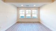 Located at 7006 Brookfield Rd in Columbia, SC, this single-story, 2-bedroom, 2-bathroom home offers a well-organized and functional layout throughout its comfortable footprint. The open-concept kitchen and living area serves as the heart of the home, featuring light luxury vinyl plank flooring that extends seamlessly through the common areas. The kitchen is equipped with rich dark wood cabinetry, stainless steel appliances including a refrigerator, electric range, and microwave, as well as a peninsula with a double sink — ideal for both everyday cooking and casual dining. The living room benefits from recessed lighting and a bank of large windows that invite abundant natural light. Both bedrooms are carpeted for comfort and include ceiling fans with lighting. The generously sized primary bedroom features a dedicated closet, while the second bedroom also offers a natural light-filled window. Both bathrooms are finished with wood-toned vanity cabinetry, light countertops, LVP flooring, and full tub-shower combinations with clean white surrounds. The home's neutral color palette and consistent finishes throughout create a bright, cohesive, and move-in ready atmosphere.