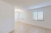 Located at 1850 NE 48th St in Pompano Beach, Florida, this single-story, 3-bedroom, 2-bathroom home offers a straightforward and functional layout. Light-tone ceramic tile flooring runs consistently throughout the entire home, contributing to a clean, cohesive aesthetic.

The combined living and dining area serves as the heart of the home, brightened by multiple windows fitted with horizontal blinds that allow natural light to filter in. A pendant light fixture highlights the dining portion of this open space. Textured ceilings are present throughout the home.

The kitchen features warm wood cabinetry, granite-look countertops, a stainless steel sink, and a window that brings in additional natural light — offering a practical and functional cooking space.

The three bedrooms are well-proportioned, with the primary bedroom providing a comfortable amount of space. Several rooms feature windows with outdoor views of surrounding greenery. The home includes five closets in total, providing generous storage across the floor plan.

The two bathrooms are clean and functional, with one featuring a full tub-shower combination with a window above. A hallway connects the bedrooms and living spaces, contributing to an efficient, easy-to-navigate layout throughout this Pompano Beach residence.