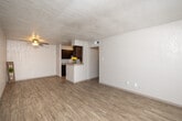 Located at 2501 Lake Rd in Huntsville, Texas, this single-floor unit offers a practical and comfortable layout across well-defined living spaces. The living area greets you with warm wood-look flooring, a ceiling fan, and a textured ceiling, creating a bright and welcoming atmosphere. A large window with horizontal blinds allows natural light to fill the room, enhancing its open feel.

The galley-style kitchen is a standout feature, lined on both sides with rich dark-wood cabinetry and granite-style countertops. Stainless steel appliances — including a refrigerator, electric range, microwave, and dishwasher — are complemented by a stainless steel sink and a tile backsplash. A pass-through peninsula connects the kitchen to the living area, offering added functionality and an open sightline between the two spaces.

The bedroom features soft carpeting underfoot, a ceiling fan, and a window with exterior views, providing a cozy and restful retreat. The bathroom is fitted with wood-look flooring, a full tub-shower combination with floor-to-ceiling earth-toned tile surround, and a curved shower curtain rod for added comfort. Throughout the unit, textured walls and consistent flooring choices create a cohesive and clean aesthetic well-suited for everyday living.