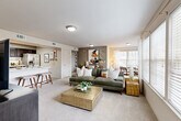 This thoughtfully designed 2-bedroom, 4-bathroom residence in Temple, TX features a single-story open-concept layout that maximizes comfort and functionality. The combined living and dining area is bright and welcoming, with large windows dressed in blinds that allow generous natural light to filter through, complemented by soft wall-to-wall carpeting underfoot. The kitchen is a standout feature, showcasing rich dark cabinetry, light marble-style countertops, a classic subway tile backsplash, and a full suite of stainless steel appliances including a French door refrigerator and electric range. A breakfast bar connects the kitchen seamlessly to the living space. The primary bedroom offers a relaxing retreat with a ceiling fan, plush carpeting, and a spacious walk-in closet with wire shelving. The second bedroom is equally comfortable, featuring a ceiling fan and bright windows. The bathrooms include practical finishes with wood-look tile flooring. Additional highlights include a dedicated entrance, a storage closet, and neutral tones throughout that create a clean, cohesive aesthetic. This residence combines practical design with modern finishes for comfortable everyday living.