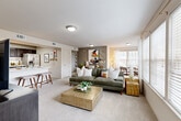 This thoughtfully designed 2-bedroom, 4-bathroom residence in Temple, TX features a single-story open-concept layout that maximizes comfort and functionality. The combined living and dining area is bright and welcoming, with large windows dressed in blinds that allow generous natural light to filter through, complemented by soft wall-to-wall carpeting underfoot. The kitchen is a standout feature, showcasing rich dark cabinetry, light marble-style countertops, a classic subway tile backsplash, and a full suite of stainless steel appliances including a French door refrigerator and electric range. A breakfast bar connects the kitchen seamlessly to the living space. The primary bedroom offers a relaxing retreat with a ceiling fan, plush carpeting, and a spacious walk-in closet with wire shelving. The second bedroom is equally comfortable, featuring a ceiling fan and bright windows. The bathrooms include practical finishes with wood-look tile flooring. Additional highlights include a dedicated entrance, a storage closet, and neutral tones throughout that create a clean, cohesive aesthetic. This residence combines practical design with modern finishes for comfortable everyday living.