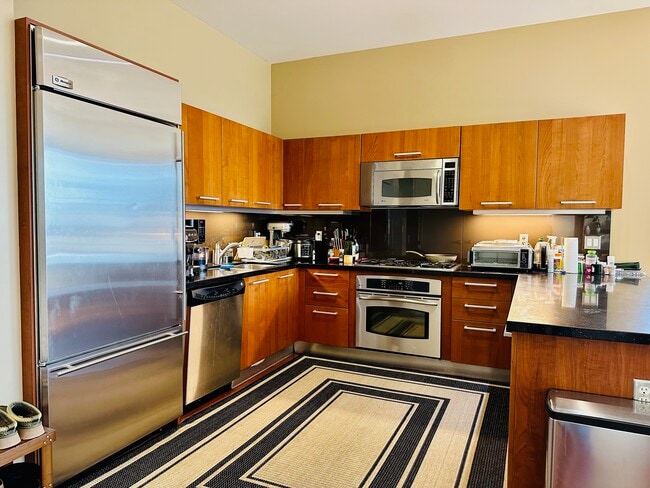 Kitchen w/ stainless steel appliances - 801 S Grand Ave