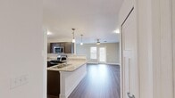 Located at 100 Mountain Flat Dr NE in Huntsville, Alabama, this single-story, one-bedroom, one-bathroom unit offers a thoughtfully designed layout that maximizes its compact footprint. The open-concept living and kitchen area serves as the heart of the space, where wood-look plank flooring, neutral wall tones, and a ceiling fan create a clean, modern atmosphere. Natural light filters in through a front-facing door with a window, brightening the living area.

The kitchen is well-equipped with dark espresso-toned cabinetry, light granite-style countertops, and a full suite of stainless steel appliances, including a range, over-the-range microwave, refrigerator, and dishwasher. Pendant lighting over the breakfast bar adds a polished touch, and a separate pantry provides additional storage.

The bedroom features neutral carpet, a ceiling fan, and a window that introduces natural light. A walk-in closet with built-in wire shelving and organizational systems offers practical storage solutions.

The bathroom includes a granite-style vanity top, wood-look flooring, a large mirror, and a window for natural ventilation. Grab bars are installed for added accessibility, reflecting a thoughtful design approach throughout the unit.