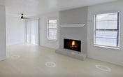 This contemporary 1-bedroom apartment offers 660 square feet of thoughtfully designed living space. The kitchen showcases a modern renovation with sleek white cabinetry, subway tile backsplash, and stainless steel appliances. The galley-style layout maximizes efficiency while providing ample counter space.

The living room serves as the heart of the home, featuring a striking fireplace as its focal point. Flanked by windows on either side, this space benefits from natural light and offers a warm, inviting atmosphere. Light-colored flooring throughout enhances the sense of spaciousness.

The bedroom, measuring 170 square feet, is generously sized and includes a ceiling fan for comfort. Plush carpeting adds a cozy touch to this private retreat. The bathroom, while compact, is well-appointed with updated fixtures and a shower/tub combination.

The apartment's open concept design creates a seamless flow between spaces, ideal for both everyday living and entertaining. Additional features include a hallway for added privacy and storage. With its modern amenities and efficient use of space, this apartment offers a comfortable and stylish urban living experience.