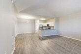 Located in Highlands Ranch, CO, this well-appointed three-bedroom, two-bathroom single-story home offers a thoughtfully designed layout that maximizes comfort and functionality. The open-concept living, dining, and kitchen area serves as the heart of the home, featuring vaulted ceilings that lend a sense of spaciousness and a large window that fills the space with natural light. Wood-style plank flooring runs throughout the main living areas, adding warmth and continuity.

The kitchen is a standout feature, equipped with stainless steel appliances including a refrigerator, range, microwave, and dishwasher. Crisp white cabinetry pairs elegantly with granite-style countertops and a tiled backsplash, while a peninsula with a built-in sink provides additional prep space and casual seating.

Each of the three bedrooms offers a comfortable retreat, with plush carpeting, generous closet space, and windows overlooking the surrounding greenery. The primary bedroom includes a dedicated walk-in closet with built-in shelving. Both bathrooms are finished with matching countertops and white cabinetry, with one featuring a full tub-shower combination. Additional conveniences include a pantry, in-unit laundry, and ample closet storage throughout.