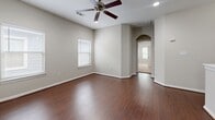 This well-appointed two-story home offers a thoughtfully designed layout across two floors, providing ample space for comfortable living. The lower level features rich dark hardwood flooring, crown molding, recessed lighting, and an open layout with a staircase leading to the upper floor, along with an attached garage with concrete flooring and an automatic door.

The main level showcases a combined dining and kitchen area where rich cherry wood cabinetry, granite countertops, a center island, stainless steel appliances, and light tile flooring come together to create a functional and attractive space. The adjacent dining area features elegant chandelier lighting and matching tile floors. A dedicated laundry room with overhead cherry wood cabinetry provides added convenience.

Upstairs, three bedrooms offer comfortable retreats, each with plush carpeting and ceiling fans. Secondary bedrooms include built-in double-door closets. The spacious primary bedroom is complemented by a walk-in closet with wrap-around shelving and a well-appointed en-suite bathroom featuring a glass-enclosed tile shower, a soaking tub, a granite-topped vanity, and a window overlooking greenery. The home's neutral gray tones and consistent finishes throughout lend a cohesive, move-in-ready aesthetic.