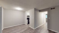 Located at 461 Forest Hill Rd in Macon, Georgia, this single-floor unit offers a thoughtfully updated interior with a clean, neutral aesthetic throughout. The open living area welcomes you with durable hardwood-style flooring, light gray walls, and a textured ceiling, creating a bright and airy atmosphere. A sliding glass door floods the space with natural light while providing access to the outdoors.

The galley-style kitchen is well-appointed with white cabinetry, granite-look countertops, a subway tile backsplash, a stainless steel sink, and black appliances including a range and refrigerator, complemented by light hardwood-style flooring for a cohesive look.

The bedrooms are finished with plush carpeting and feature ceiling fans for added comfort. The primary bedroom is notably spacious, offering dual closets with ample storage, while a secondary bedroom includes a window that brings in natural light. Additional closet space is found throughout the unit, providing generous storage options.

The bathroom is clean and functional, featuring a full tub-shower combination, a single vanity with white cabinetry, and light hardwood-style flooring. The overall design of this unit prioritizes practicality and modern comfort in a well-maintained residential setting.