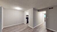 Located at 461 Forest Hill Rd in Macon, Georgia, this single-floor unit offers a thoughtfully updated interior with a clean, neutral aesthetic throughout. The open living area welcomes you with durable hardwood-style flooring, light gray walls, and a textured ceiling, creating a bright and airy atmosphere. A sliding glass door floods the space with natural light while providing access to the outdoors.

The galley-style kitchen is well-appointed with white cabinetry, granite-look countertops, a subway tile backsplash, a stainless steel sink, and black appliances including a range and refrigerator, complemented by light hardwood-style flooring for a cohesive look.

The bedrooms are finished with plush carpeting and feature ceiling fans for added comfort. The primary bedroom is notably spacious, offering dual closets with ample storage, while a secondary bedroom includes a window that brings in natural light. Additional closet space is found throughout the unit, providing generous storage options.

The bathroom is clean and functional, featuring a full tub-shower combination, a single vanity with white cabinetry, and light hardwood-style flooring. The overall design of this unit prioritizes practicality and modern comfort in a well-maintained residential setting.