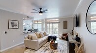 Located in Cedar Park, TX, this well-appointed 2-bedroom, 1-bathroom residence offers a thoughtfully designed single-floor layout. The open living room is a welcoming centerpiece, featuring crown molding, a ceiling fan, and a large sliding glass door that floods the space with natural light while providing access to a private balcony overlooking lush greenery. Built-in shelving along one wall adds both function and character to the living area.

The kitchen is designed for efficiency, featuring rich dark wood cabinetry, granite countertops, a gas range, stainless steel appliances, and a convenient pass-through to the dining area. The adjacent dining space is bright and intimate, enhanced by a pendant light fixture, decorative mirrors, and a large window that frames outdoor views.

The primary bedroom is a comfortable retreat with crown molding, a ceiling fan, neutral tones, and access to a spacious walk-in closet outfitted with multi-tiered hanging rods. The full bathroom offers a dual-sink vanity with dark wood cabinetry, a large mirror, and a tiled tub-shower combination. A welcoming entrance hall and in-unit laundry access complete this efficiently designed and well-finished home.