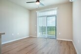 Located at 2692 Botanical Dr in Fitchburg, WI, this efficiently designed one-bedroom, one-bathroom unit offers a well-organized single-floor layout. The open-concept kitchen is a standout feature, showcasing white shaker cabinetry, light quartz countertops, a subtle tile backsplash, and a full suite of stainless steel appliances including a refrigerator, range, microwave, and dishwasher. A freestanding island provides additional prep and dining space. Light hardwood-style flooring runs throughout, contributing to a clean, cohesive aesthetic. Recessed lighting and a ceiling fan keep the living area bright and comfortable, while a sliding glass door opens to a private patio with sweeping views of lush green fields. The bedroom is a calm, sunlit retreat with large windows framing panoramic outdoor scenery and a ceiling fan for added comfort. Two closets offer ample storage throughout the unit. The bathroom is clean and functional, featuring hardwood-style flooring, a bathtub, and a wall-mounted towel bar. A dedicated in-unit laundry area adds everyday convenience. Neutral wall tones and modern finishes give the space a fresh, move-in-ready feel.