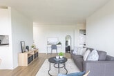 Located at 718 Lawrence Road in Hamilton, Ontario, this thoughtfully designed one-bedroom, one-bathroom unit offers a bright and functional layout across a single floor. The open-concept living and dining area is anchored by large sliding doors that lead to a private balcony, flooding the space with natural light and offering pleasant outdoor views. Light-toned hardwood-style flooring runs throughout, complementing the clean, neutral palette of the white walls and contemporary finishes.

The galley-style kitchen is well-appointed with crisp white cabinetry extending to the ceiling for ample storage, light grey subway tile backsplash, quartz countertops, a stainless steel sink, and stainless steel appliances including a range and over-the-range microwave. The bedroom is a serene, light-filled retreat featuring a closet and a window with natural light. The four-piece bathroom includes a combined tub and shower, white vanity with storage, and tile flooring. A hallway connects the rooms efficiently, with space that also accommodates in-unit laundry. This unit presents a clean, modern aesthetic well-suited for comfortable everyday living in a convenient Hamilton location.