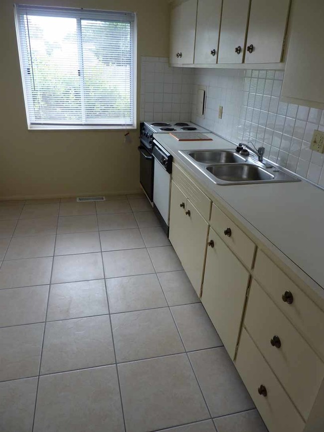 Updated kitchen with tile floor. - Princeton Park Apartments