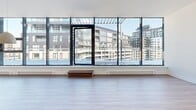 Located at 205 Avenue De l'Équinoxe in Brossard, Quebec, this contemporary 2-bedroom, 2-bathroom unit offers a well-designed open-concept layout with modern finishes throughout. The living area is a standout feature, defined by expansive floor-to-ceiling windows that flood the space with natural light and frame sweeping views of the surrounding urban landscape. Light-toned laminate flooring runs throughout, complementing the clean, neutral palette of the interiors.

The kitchen is sleek and functional, showcasing high-gloss white upper cabinetry, dark wood-toned lower cabinets, a dark stone countertop island with an integrated sink, a tiled backsplash, and stainless steel appliances. A discreetly placed in-unit stacked washer and dryer adds everyday convenience.

Both bedrooms are well-proportioned, bright, and feature light laminate flooring, with the primary bedroom benefiting from large windows and a dedicated closet. The second bedroom also includes a closet with built-in hanging storage. The two bathrooms are finished in a contemporary style — one features a glass-enclosed shower with taupe tile surround and a floating white vanity, while the second offers a soaker tub with tiled surround. The overall ambiance is clean, modern, and urban.
