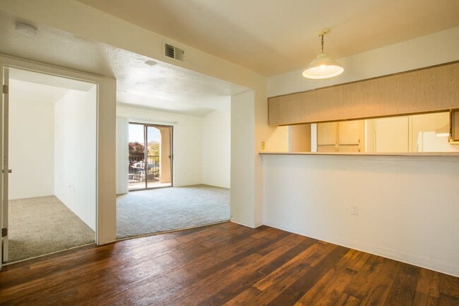 Open living area with rich wood vinyl plank flooring - Rio Volcan