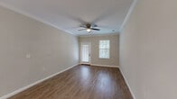 Located at 3825 Ladson Rd in North Charleston, SC, this well-designed 2-bedroom, 2-bathroom single-story home offers a thoughtful layout with quality finishes throughout. The open-concept kitchen and living area serves as the heart of the home, where rich hardwood-style flooring flows underfoot and crown molding adds a refined touch. The living room features a ceiling fan, natural light from a rear door and adjacent window, and a clean, neutral palette that creates a welcoming ambiance.

The kitchen is outfitted with dark espresso cabinetry, granite countertops, a classic subway tile backsplash, and stainless steel appliances. A peninsula with additional cabinetry and pendant lighting bridges the kitchen and living spaces seamlessly.

Both bedrooms are carpeted for comfort and include ceiling fans. The spacious primary bedroom offers generous closet space, including a walk-in closet with wire shelving systems. The second bedroom also provides closet access and ample room.

The bathrooms are finished with tile flooring and subway-tiled tub-shower surrounds with brushed nickel fixtures. A utility room and three closets round out the functional layout, providing excellent storage throughout this move-in-ready North Charleston home.