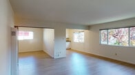 Located at 1201 Liberty St in El Cerrito, California, this single-floor residence offers a thoughtfully laid-out living space with a clean, neutral aesthetic throughout. The open living and dining area is finished with light-toned hardwood-style flooring that extends through the main spaces, creating a bright and cohesive feel. Multiple windows allow natural light to flow freely, enhancing the airy atmosphere of the interior.

The kitchen is well-appointed with ample white cabinetry, generous granite countertops in a speckled earth-tone pattern, and a stainless steel double-basin sink. A pass-through opening connects the kitchen to the living area, promoting an open and functional flow between spaces.

The bedrooms feature plush carpeting and individual closets with sliding doors, offering comfortable and practical retreats. Each bedroom includes window blinds for privacy and light control.

Two bathrooms serve the residence. The full bathroom includes a tub-shower combination with sliding glass doors, a granite-topped vanity, and a skylight that brings in additional natural light. The second bathroom features a granite countertop vanity and mirrored medicine cabinet, maintaining the consistent finishes found throughout the home. A wall-mounted heating unit is also present in the main living area, rounding out the functional amenities of this well-maintained residence.