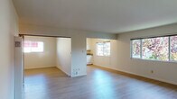Located at 1201 Liberty St in El Cerrito, California, this single-floor residence offers a thoughtfully laid-out living space with a clean, neutral aesthetic throughout. The open living and dining area is finished with light-toned hardwood-style flooring that extends through the main spaces, creating a bright and cohesive feel. Multiple windows allow natural light to flow freely, enhancing the airy atmosphere of the interior.

The kitchen is well-appointed with ample white cabinetry, generous granite countertops in a speckled earth-tone pattern, and a stainless steel double-basin sink. A pass-through opening connects the kitchen to the living area, promoting an open and functional flow between spaces.

The bedrooms feature plush carpeting and individual closets with sliding doors, offering comfortable and practical retreats. Each bedroom includes window blinds for privacy and light control.

Two bathrooms serve the residence. The full bathroom includes a tub-shower combination with sliding glass doors, a granite-topped vanity, and a skylight that brings in additional natural light. The second bathroom features a granite countertop vanity and mirrored medicine cabinet, maintaining the consistent finishes found throughout the home. A wall-mounted heating unit is also present in the main living area, rounding out the functional amenities of this well-maintained residence.