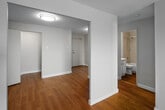 Located at 11 Overlea Dr in Kitchener, Ontario, this well-laid-out one-bedroom, one-bathroom unit offers a clean and functional living environment across a single floor. Warm hardwood-style flooring flows consistently throughout the space, lending a cohesive and inviting feel to every room.

The living room is a standout feature, bathed in natural light through a large sliding glass door that opens to a balcony with open outdoor views of the surrounding Kitchener landscape. The neutral palette of the walls complements the bright, airy atmosphere throughout.

The bedroom is generously proportioned, featuring a window with a roller blind that allows for natural light and a built-in closet with a hanging rod for practical storage. Baseboard heating keeps the room comfortable year-round.

The kitchen is efficiently designed, equipped with a white electric range, overhead exhaust hood, and cabinetry, providing all the essentials for everyday cooking. Adjacent hallways connect the rooms with ease, contributing to a logical and practical floor plan.

The bathroom features a full tub-shower combination with classic tile surround in a neutral stone-like finish and chrome fixtures, offering a clean and timeless look. Overall, this unit presents a tidy, move-in-ready space with a bright and functional character.