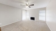 Located at 1135 Silverwood Dr in Arlington, Texas, this well-appointed one-bedroom, one-bathroom residence offers a practical and comfortable single-floor layout. The combined kitchen and living room serves as the heart of the home, featuring plush neutral carpeting, a ceiling fan with light fixture, and multiple windows dressed with blinds that invite natural light. A white tile-surround wood-burning fireplace anchors the living area, adding warmth and character to the space.

The kitchen is efficiently designed with wood-look vinyl flooring, white cabinetry, a subway tile backsplash, and black appliances including a range, microwave, refrigerator, and dishwasher. A louvered bi-fold closet door provides additional storage within the kitchen area.

The bedroom offers a comfortable footprint with soft carpeting, a ceiling fan, a window for natural light, and direct access to a dedicated closet. The bathroom is tastefully updated with large-format marble-look tile surrounding the full soaking tub and shower, complemented by wood-look flooring and a granite-style vanity countertop.

Neutral gray walls and textured ceilings carry throughout the home, creating a cohesive and move-in-ready aesthetic suited for comfortable everyday living.