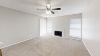 Located at 1135 Silverwood Dr in Arlington, Texas, this well-appointed one-bedroom, one-bathroom residence offers a practical and comfortable single-floor layout. The combined kitchen and living room serves as the heart of the home, featuring plush neutral carpeting, a ceiling fan with light fixture, and multiple windows dressed with blinds that invite natural light. A white tile-surround wood-burning fireplace anchors the living area, adding warmth and character to the space.

The kitchen is efficiently designed with wood-look vinyl flooring, white cabinetry, a subway tile backsplash, and black appliances including a range, microwave, refrigerator, and dishwasher. A louvered bi-fold closet door provides additional storage within the kitchen area.

The bedroom offers a comfortable footprint with soft carpeting, a ceiling fan, a window for natural light, and direct access to a dedicated closet. The bathroom is tastefully updated with large-format marble-look tile surrounding the full soaking tub and shower, complemented by wood-look flooring and a granite-style vanity countertop.

Neutral gray walls and textured ceilings carry throughout the home, creating a cohesive and move-in-ready aesthetic suited for comfortable everyday living.