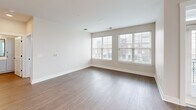 This contemporary apartment, located at 22 S Center St in Hickory, NC, offers 1230 square feet of thoughtfully designed living space. The open-concept layout showcases a modern kitchen with sleek white cabinetry, subway tile backsplash, and stainless steel appliances. The living area boasts hardwood floors and large windows, flooding the space with natural light.

The two bedrooms are generously sized, with the primary bedroom measuring an impressive 190 square feet. All three bathrooms feature modern fixtures and finishes, with at least one including a double vanity. The apartment includes two closets for ample storage, one of which is a walk-in design with built-in shelving.

Throughout the space, recessed lighting and ceiling fans add both functionality and style. The neutral color palette, combined with the mix of hardwood and plush carpeting, creates a cohesive and inviting atmosphere. Large windows in multiple rooms offer views of the surrounding area and contribute to the bright, airy feel of the home.

This single-story apartment seamlessly blends comfort and contemporary design, making it an ideal living space for those seeking a modern urban lifestyle in Hickory, North Carolina.