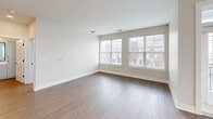 This contemporary apartment, located at 22 S Center St in Hickory, NC, offers 1230 square feet of thoughtfully designed living space. The open-concept layout showcases a modern kitchen with sleek white cabinetry, subway tile backsplash, and stainless steel appliances. The living area boasts hardwood floors and large windows, flooding the space with natural light.

The two bedrooms are generously sized, with the primary bedroom measuring an impressive 190 square feet. All three bathrooms feature modern fixtures and finishes, with at least one including a double vanity. The apartment includes two closets for ample storage, one of which is a walk-in design with built-in shelving.

Throughout the space, recessed lighting and ceiling fans add both functionality and style. The neutral color palette, combined with the mix of hardwood and plush carpeting, creates a cohesive and inviting atmosphere. Large windows in multiple rooms offer views of the surrounding area and contribute to the bright, airy feel of the home.

This single-story apartment seamlessly blends comfort and contemporary design, making it an ideal living space for those seeking a modern urban lifestyle in Hickory, North Carolina.