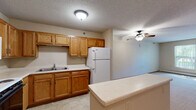 Located at 115 East Ave in Mahtomedi, Minnesota, this two-bedroom, one-bathroom residence offers a practical and comfortable single-floor layout. The kitchen is well-appointed with warm oak cabinetry extending to the ceiling, ample counter space, a double-basin sink, and white appliances including a range, built-in microwave, and refrigerator. Light tile flooring completes the functional cooking space. The spacious primary bedroom features plush carpeting, a ceiling fan, a baseboard heating unit, and a window that brings in natural light and outdoor views. It is complemented by a generously sized walk-in closet outfitted with wire shelving and a hanging rod for organized storage. The second bedroom also offers carpeted flooring, a window with natural light, a baseboard heater, and a standard closet with sliding wood-panel doors. The bathroom includes a wood-toned vanity with a built-in medicine cabinet, a mirror, tile flooring, and overhead lighting. Throughout the residence, neutral tones, textured ceilings, and wood-trimmed baseboards create a cohesive and understated aesthetic. The overall layout is efficient and well-organized, making this Mahtomedi home a comfortable and move-in-ready option.