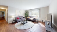 Located at 120 Cambridge Ave in Waukesha, Wisconsin, this single-floor 2-bedroom, 2-bathroom residence offers a practical and comfortable layout designed for everyday living. Rich hardwood flooring runs throughout the home, lending warmth and continuity across all rooms.

The living room is a bright, welcoming space anchored by a large window with vertical blinds that invites abundant natural light and outdoor views. It flows naturally into a dedicated dining area, creating an open, connected feel ideal for entertaining. The kitchen features warm wood cabinetry, light stone-style countertops, a stainless steel range, dishwasher, and refrigerator, all arranged in an efficient galley-style layout.

The spacious primary bedroom includes large sliding wood-panel closet doors and a bright window overlooking greenery. The second bedroom is also well-sized and benefits from similar natural light. A dedicated walk-in closet with wire shelving provides additional storage. Both bathrooms are clean and functional, each equipped with a full tub-shower combination.

A connecting hallway ties the layout together efficiently. The home's neutral color palette, consistent flooring, and ceiling fans contribute to an understated, livable ambiance throughout.