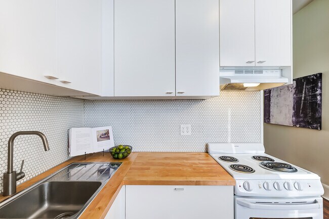 Kitchen- new renovation includes modern backsplash, farmhouse faucet, and butcher block countertops! - 309 E 13th St