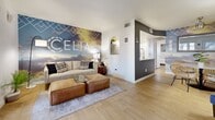Located at 4722 E Bell Rd in Phoenix, AZ, this 2-bedroom, 1-bathroom unit at Celia offers a well-designed single-floor layout with a clean, contemporary aesthetic throughout. Light wood-style flooring flows seamlessly across every room, creating a warm and cohesive feel.

The open living area is bright and welcoming, anchored by large French-style doors and sidelights that invite natural light and provide outdoor views. A bold feature wall adds a distinctive design element, while an arched pass-through connects the living space to the kitchen area.

The kitchen is outfitted with white upper cabinetry, contrasting grey lower cabinets, white quartz-style countertops, and stainless steel appliances including a range and over-the-range microwave. In-unit washer and dryer connections are conveniently located just off the kitchen.

The primary bedroom is generously proportioned, offering mirrored sliding closet doors that enhance the sense of space and natural light from a well-placed window. The second bedroom mirrors the clean, bright style with additional wall space for personalization.

The bathroom features a full tub-shower combination, grey vanity cabinetry with a white countertop, and wood-style tile flooring, maintaining the consistent modern palette found throughout the home.