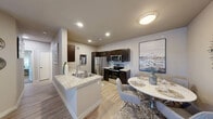 Located near McKinney Falls State Park in Austin, TX, this thoughtfully designed 2-bedroom, 2-bathroom residence offers a seamless blend of comfort and contemporary style across a single floor. The open-concept layout connects the living, dining, and kitchen areas, creating an inviting and functional space. The living room features wood-look flooring, a ceiling fan, a bold accent wall, and French doors that welcome natural light and outdoor views. The kitchen is well-equipped with dark espresso cabinetry, granite-style countertops, stainless steel appliances, and a peninsula with a built-in sink — ideal for both cooking and casual dining. A dedicated dining area sits adjacent, completing the shared living space. Both bedrooms are carpeted for comfort and include ceiling fans, closet storage, and natural light from large windows. The primary bedroom offers a spacious walk-in closet with wire shelving. The bathrooms are finished with large-format gray tile in the tub-shower surrounds, offering a clean and modern aesthetic. Neutral tones and wood-look flooring throughout the common areas tie the space together with a warm, cohesive ambiance.