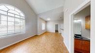 Located at 3807 Plantation Grove Blvd in Mission, TX, this single-story 2-bedroom, 2-bathroom home offers a well-designed layout with comfortable living spaces throughout. The living area makes a strong first impression with soaring vaulted ceilings, a ceiling fan, and an arched window alongside additional windows that fill the room with natural light and views of the surrounding greenery. Light tile flooring runs through the main living and kitchen areas, adding a clean, cohesive look. The kitchen is well-appointed with warm wood cabinetry, dark granite countertops, stainless steel appliances including a range and dishwasher, and a breakfast bar peninsula that opens to the main living space. A full-size refrigerator and dedicated laundry area add everyday convenience. The spacious primary bedroom features wood-look laminate flooring, a ceiling fan, and direct access to an ensuite bathroom complete with a vanity featuring granite countertops and a full soaking tub. A walk-in closet provides generous storage. The second bedroom also showcases wood-look flooring, a ceiling fan, and a bright window with outdoor views. A second full bathroom serves this bedroom and guests. Neutral tones throughout the home create a calm, versatile backdrop well-suited to a variety of living styles.