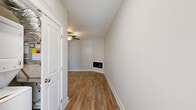 Located at 158 English Commons Dr in Lynchburg, Virginia, this single-floor residence offers a thoughtfully designed layout encompassing one bedroom, one bathroom, a laundry area, and a dedicated closet. The open-concept kitchen and living room serve as the heart of the home, finished with warm wood-look luxury vinyl plank flooring throughout. A sleek built-in linear fireplace anchors the living area, while a ceiling fan adds both style and functionality. The kitchen is equipped with crisp white shaker cabinetry accented by matte black hardware, bright white countertops, stainless steel appliances, and ample storage — a clean, modern aesthetic that is both functional and visually appealing. The bedroom features plush carpeting, a ceiling fan, and a window that invites natural light and neighborhood views. A dedicated closet provides convenient storage. The bathroom is finished with wood-look flooring, white cabinetry, and a full tub-shower combination with clean white surrounds. Throughout the home, neutral tones, white trim, and consistent modern finishes create a cohesive, move-in-ready environment suited for comfortable everyday living.