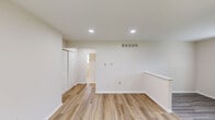 Located at 6 N Locust Ave in Marlton, NJ, this well-designed one-bedroom, one-bathroom unit offers a practical and comfortable single-floor layout. The kitchen is efficiently equipped with dark-toned cabinetry, light wood-look flooring, and a full suite of stainless steel appliances including a gas range, microwave, and refrigerator. A window above the sink allows natural light to brighten the workspace. The spacious bedroom features soft wall-to-wall carpeting, neutral walls, and two windows fitted with blinds that bring in ample natural light. A large double sliding-door closet provides generous storage. A hallway connects the rooms, contributing to the unit's smooth flow. The bathroom is a standout feature, showcasing floor-to-ceiling large-format marble-look tile surrounding a clean white soaking tub, lending a sleek and elegant feel. A window in the bathroom adds ventilation and light. Throughout the unit, a clean, neutral color palette creates a calm and move-in-ready atmosphere. This unit offers a functional and well-appointed living space suited for comfortable everyday living in a residential Marlton neighborhood.