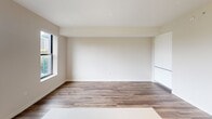 Located at 500 N Andrews Ave in the heart of Fort Lauderdale, FL, this thoughtfully designed unit offers a clean, contemporary aesthetic throughout its single-floor layout. The open-concept kitchen and living area forms the centerpiece of the space, featuring light wood-look flooring, crisp white walls, and an abundance of natural light streaming through large windows and balcony access that overlooks lush surrounding greenery and city views.

The kitchen is outfitted with sleek, floor-to-ceiling white cabinetry, a marble-style tile backsplash, and a full suite of stainless steel GE appliances, including a French door refrigerator, dishwasher, microwave, and range. A light-toned countertop with an undermount sink completes the polished, functional design. The adjacent living area benefits from the same warm wood flooring and open sightlines, creating a cohesive and airy atmosphere.

The bathroom showcases a refined, spa-like aesthetic with a light wood vanity, white quartz countertop, a vessel-style sink, and a large backlit LED mirror. A marble-tiled walk-in shower adds an elevated touch to the space. A hallway connects the main living areas efficiently, contributing to the unit's well-organized flow. Overall, the space presents a modern and inviting environment suited for contemporary urban living.