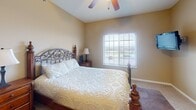 Located at 4301 W 57th St in Sioux Falls, South Dakota, this single-floor residence offers a well-planned layout with comfortable living spaces throughout. The living room serves as the heart of the home, featuring vaulted ceilings, plush carpeting, and a large sliding glass door that floods the space with natural light and provides direct access to a balcony with outdoor views. An elegant multi-arm chandelier adds a refined touch to the living and dining area, which flows seamlessly for everyday living and entertaining. The kitchen is outfitted with warm-toned wood cabinetry, light countertops, and stainless steel appliances, including an electric range and over-the-range microwave, offering both style and functionality. The bedrooms are carpeted and well-lit, each featuring windows that bring in natural light. The primary bedroom includes a ceiling fan, a sizable window with outdoor views, and wall-mounted media provisions. The bathroom features tile flooring, rich wood cabinetry with an extended vanity, a large mirror, and a tub-shower combination with a curtained enclosure. Throughout the home, neutral wall tones and consistent finishes create a cohesive, welcoming ambiance suited for comfortable everyday living.