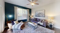 Located at 8816 Aspinwall Dr in Charlotte, NC, this thoughtfully designed 2-bedroom, 2-bathroom single-floor home offers a comfortable and modern living experience. The open-concept kitchen is a standout feature, boasting dark espresso cabinetry, granite countertops, dark hardwood-style flooring, and a breakfast bar island with pendant lighting — ideal for both casual dining and entertaining. Black appliances complement the sleek, contemporary aesthetic throughout.

The living room is bright and inviting, highlighted by a bold accent wall, a ceiling fan, and French doors that open to a private balcony with outdoor views — an excellent spot for relaxing. The spacious primary bedroom features plush carpeting, a ceiling fan, and large windows that bring in abundant natural light, creating a peaceful retreat. The second bedroom also offers generous proportions, vaulted ceilings, and its own bold accent wall adding visual interest.

Both bathrooms are finished consistently with granite-top vanities, dark cabinetry, and hardwood-style flooring, offering a polished, cohesive look. Each bedroom is served by a dedicated closet, including a walk-in closet with wire shelving for ample organization. The home's neutral color palette, modern finishes, and functional layout make it a well-rounded and move-in-ready residence.