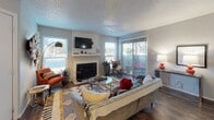 Located at 3600 W Loop 250 N in Midland, Texas, this single-story residence offers a well-designed layout that blends comfort and functionality throughout. The living room serves as the heart of the home, centered around a classic fireplace with a shiplap surround and wall-mounted television. Large windows and a sliding glass door to an outdoor patio fill the space with natural light, while wood-style flooring adds warmth and continuity underfoot. A textured ceiling and neutral walls provide a versatile backdrop throughout.

The galley-style kitchen is outfitted with grey cabinetry, ample counter space, a stainless steel double sink, and black appliances, offering an efficient and practical cooking environment. Adjacent to the kitchen, the dining area provides an intimate setting with a ceiling fan overhead and natural light from a nearby window.

The bedrooms are carpeted and feature ceiling fans, bright windows, and generous closet space — one bedroom includes a dedicated walk-in closet. The bathroom is well-appointed with grey cabinetry, a wide vanity with a large mirror, additional upper storage, and a shower-tub combination. Wood-style flooring extends into the bathroom, tying the design together cohesively throughout the home.
