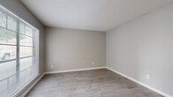 Located at 900 North Durham Drive in Houston, TX, this single-story, 2-bedroom, 2-bathroom residence offers a clean, neutral aesthetic throughout. Wood-look tile flooring runs consistently across the living areas and bedrooms, providing a cohesive and low-maintenance finish. Soft gray walls and white trim create a bright, modern backdrop in every room.

The living room is well-proportioned and receives natural light through a large window with blinds, alongside a classic six-panel entry door. Textured ceilings add visual character throughout the home.

Both bedrooms are comfortably sized — the primary bedroom offers generous floor space. Each bedroom is equipped with a ceiling fan with light fixture and includes dedicated closet space, with at least one closet featuring built-in shelving and hanging rods. Natural light filters in through window blinds in each room.

The bathrooms are functional and well-appointed. One features a full tub and shower combination with warm beige ceramic tile surround, while the other includes a white vanity with undermount sink and ample counter space.

A connecting hallway links the bedrooms and bathrooms, maintaining an efficient and logical floor plan. Three closets throughout the home provide practical storage solutions. The overall ambiance is clean, move-in ready, and well-suited for everyday living.