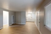 Located at 319 E Tabor Ave in Fairfield, CA, this two-bedroom, one-bathroom single-story home offers a practical and well-appointed layout. The open-concept living and kitchen area forms the heart of the home, featuring light luxury vinyl plank flooring throughout, neutral gray walls, and clean white trim. The kitchen is equipped with stainless steel appliances — including a refrigerator and electric range — complemented by white cabinetry with ample upper and lower storage and light countertops. A wall-mounted heating unit in the living area and a window air conditioning unit in the primary bedroom provide year-round comfort. The primary bedroom is a comfortable size, featuring dual closets with built-in hanging rods and a window that allows natural light to filter in. The second bedroom also benefits from natural light and its own closet. Both bedrooms continue the consistent LVP flooring found throughout the home. The full bathroom is finished with light marble-style tile flooring, a white vanity, and a full bathtub/shower combination with a window for ventilation. A connecting hallway ties all rooms together efficiently. The overall aesthetic is clean, minimal, and move-in ready.