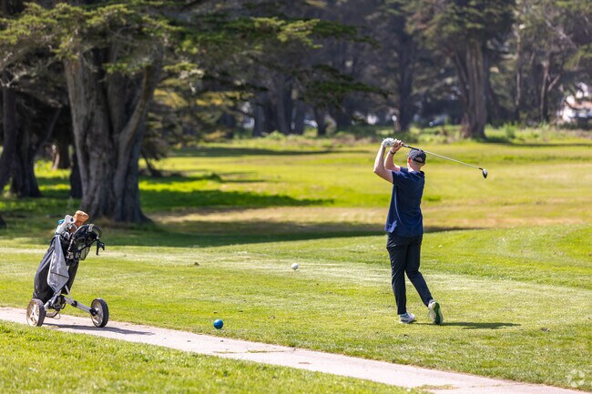 Golfer swings with a sea breeze at Sharp Park Golf Course, Pacific Heights.