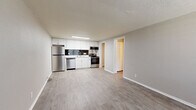 Located at 202 Safe Harbor Dr in Goodlettsville, Tennessee, this single-story, one-bedroom, one-bathroom unit offers a well-organized and functional layout across a compact but thoughtfully designed floor plan. The open-concept kitchen and living area serves as the heart of the home, featuring light wood-look flooring, neutral wall tones, and a textured ceiling. The kitchen is equipped with a full suite of stainless steel appliances — including a refrigerator, dishwasher, electric range, and over-the-range microwave — complemented by crisp white cabinetry, light countertops, and a bold dark subway tile backsplash that adds a modern contrast. A large window in the living area allows natural light to fill the space, creating a bright and airy atmosphere. The bedroom is carpeted for comfort, features crown molding, a ceiling fan with light fixture, a natural light-admitting window with a view of the outdoors, and a closet for storage. The bathroom includes a full tub-shower combination, a white vanity, and wood-look flooring that ties the space together cleanly. Additional highlights include three closets throughout, a dedicated laundry area, and a connecting hallway for seamless flow between rooms.