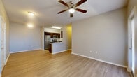 Located at 12910 Clubhouse Boulevard in San Antonio, TX, this 2-bedroom, 2-bathroom residence offers a thoughtfully designed single-floor layout that maximizes both comfort and functionality. Light-toned wood-style flooring flows throughout the main living areas, complemented by neutral walls and ceiling fans in the living room and bedrooms. The open-concept living and dining area is bright and inviting, with natural light streaming through large windows. The kitchen features rich dark-espresso cabinetry, granite countertops, a stylish tile backsplash, stainless steel appliances, and a breakfast bar peninsula that connects seamlessly to the living space. A dedicated pantry provides additional storage. Both bedrooms are carpeted and bathed in natural light from multiple windows, each equipped with a ceiling fan. The spacious primary bedroom includes a generous walk-in closet with built-in shelving. The bathrooms are finished with dark cabinetry, granite vanities, and tiled tub-shower combinations. A hallway connects the private quarters, and a balcony extends the living space outdoors. This residence also includes a pantry and two closets for ample storage throughout.